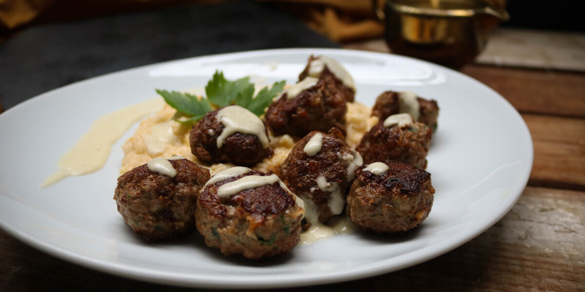 keto meatballs topped with cauliflower mash